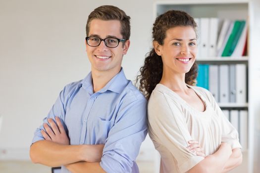 Portrait of confident business people with arms crossed standing in office