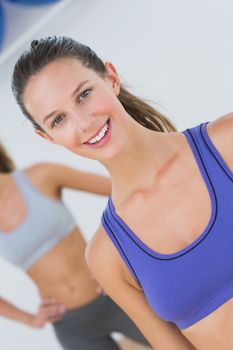 Portrait of fit young women in sports bra at fitness studio