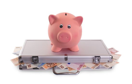 Unique pink ceramic piggy bank on top of metal case filled with money