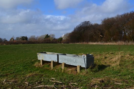 Farmers livestock water trough in field.