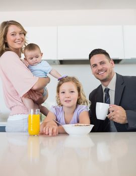 Portrait of family at breakfast table in house
