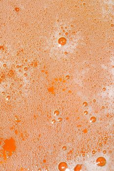 closeup of foam on top of a glass of beer