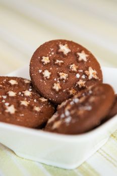 Detail of Christmas holiday dark chocolate cookies with white stars