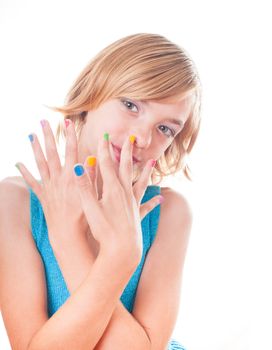Teenager blonde girl's face with multicoloured nails close up