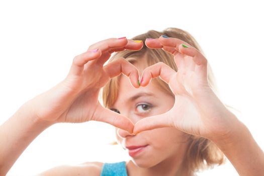 Teenager blonde girl shows heart shape  with multicoloured nails