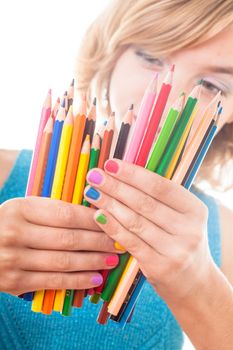 Color rainbow pencils and teenager's hands with multicoloured nails