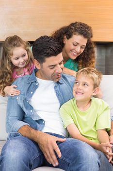 Happy family relaxing together at home in living room