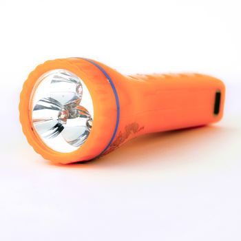 used orange flashlight isolated on white background