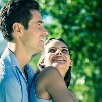 Side view of a loving and happy young couple at the park