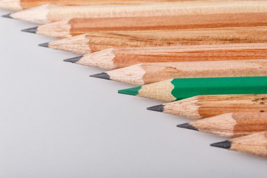 Color pencil stands out against a series of graphite pencils