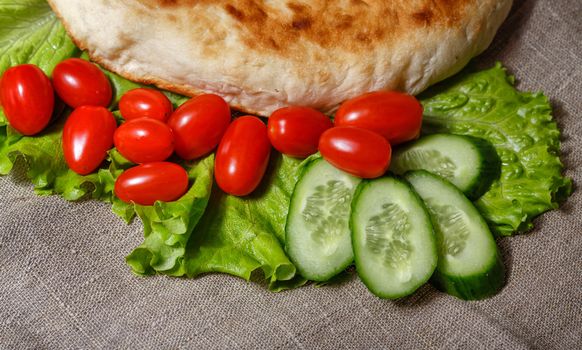 Traditionally pita with lettuce and fresh tomatoes with cucumbers shot closeup