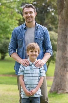 Portrait of a father and young boy standing at the park