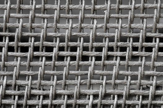 background of inter-woven strands to form a mesh pattern