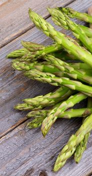 Bunch of Asparagus Sprouts isolated on Rustic Wooden background