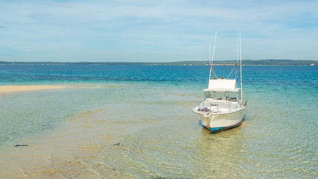 A small yacht anchored on the shores of the islands of Zanzibar