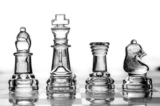 bishop, king, rook and knight chess pieces made out of glass