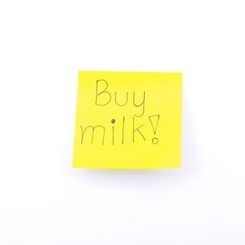 buy milk text on yellow post it isolated on white background