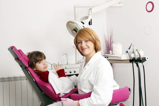 little girl and female dentist in dental practice