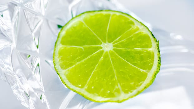 A slice of lime on a crystal clear glass place
