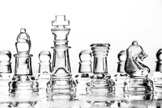 bishop, king, rook and knight chess pieces made out of glass