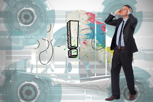 Stressed businessman with hands on head against technology wheel background