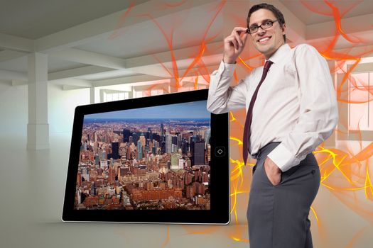 Thinking businessman touching his glasses against abstract design in orange
