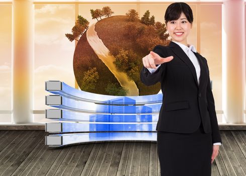 Smiling businesswoman pointing against digital earth floating in room
