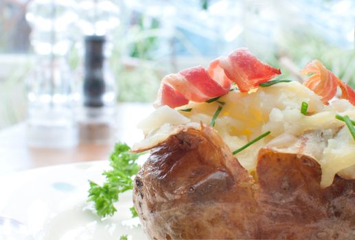 Baked jacket potato with bacon and chives