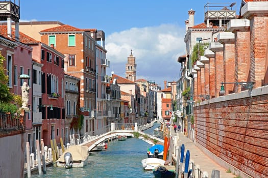 Italy. Venice. Romantic canal with bridge among old colorful houses 
