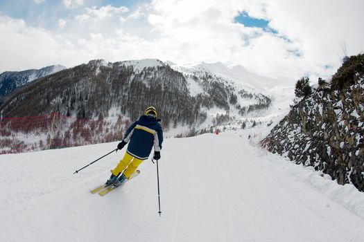 Skier rushing down the slope