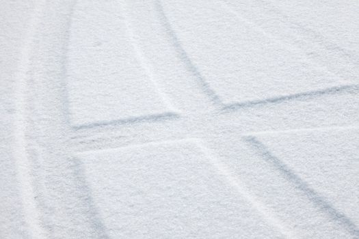 Trails of wheels in fresh snow