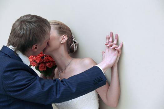 The beautiful bride and the groom in studio