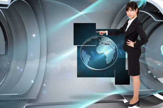 Focused businesswoman pointing against blue abstract design in structure 
