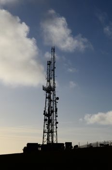 Large telecommunication mast with base station in the uk.