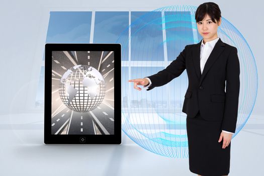 Focused businesswoman pointing against abstract blue design in white room