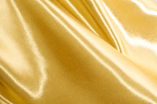 Golden satin or silk background with beautiful waves