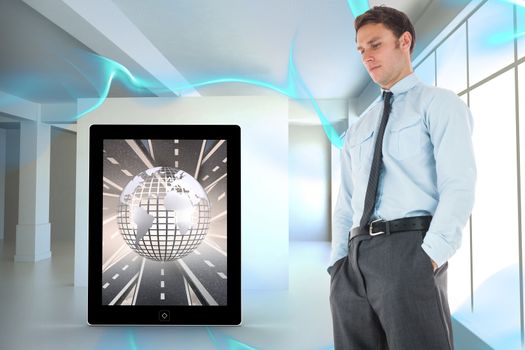 Serious businessman standing with hands in pockets against blue abstract design in room