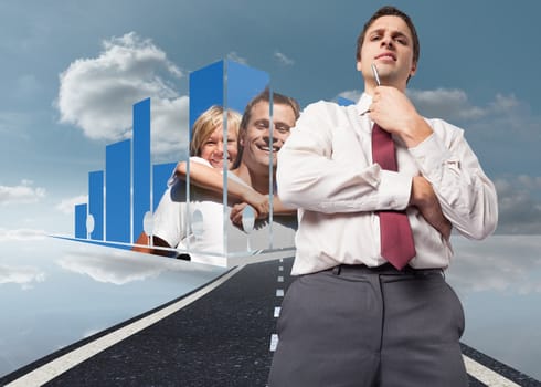 Thoughtful businessman holding pen to chin against road over water reflecting sky