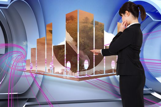 Businesswoman pointing against abstract pink design in futuristic structure