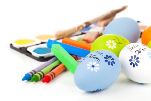 painting easter eggs on a white background.