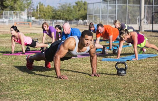 Group of adults exercising in outdoor boot camp