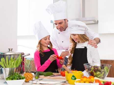 Chef master and junior pupil kid girls at cooking school with food on countertop