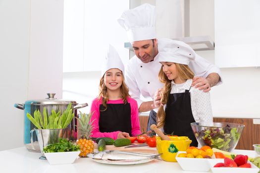 Chef master and junior pupil kid girls at cooking school with food on countertop