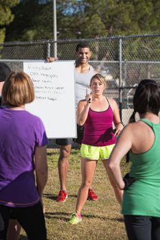 Two young fitness instructors explaining an exercise program