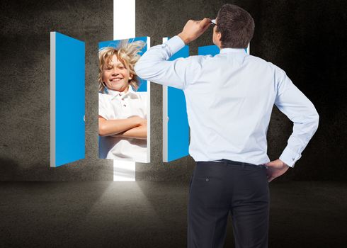 Thinking businessman tilting glasses against door in dark room