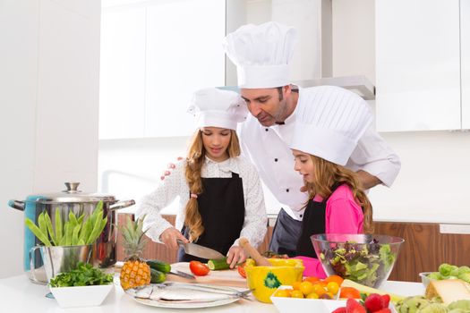 Chef master and junior pupil kid girls at cooking school with food on countertop