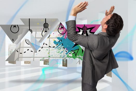 Businessman standing with arms pressing up against blue abstract design in room