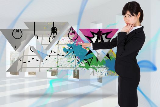 Businesswoman pointing against blue abstract design in room