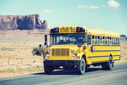school bus traveling near Monument Valley