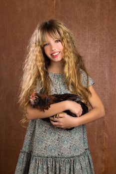 children fashion farmer girl holding hen in retro vintage background